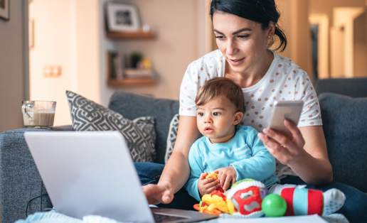 Woman with baby working on computer